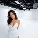 Elegant Woman in White Dress in Bright Studio