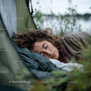 Peaceful Woman Sleeping in Tent During Outdoor Camping Adventure