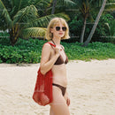 Woman in Bikini with Red Tote Bag on Tropical Beach with Palm Trees