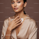 Elegant Woman Applying Moisturizer Showing Flawless Skin