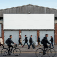 Blurred commuters walking and cycling past blank billboard