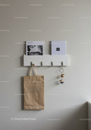 Minimalist Wall Organizer with Hooks and Decorative Accents