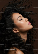 Profile of serene woman with flowing curly hair