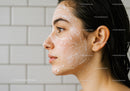 Close-up of woman cleansing skin with foam cleanser