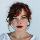 Close-Up of Red-Haired Woman with Blue Eyes and Freckles in Natural Light