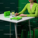 Stylish Woman in Green with Refreshing Drink in Modern Workspace