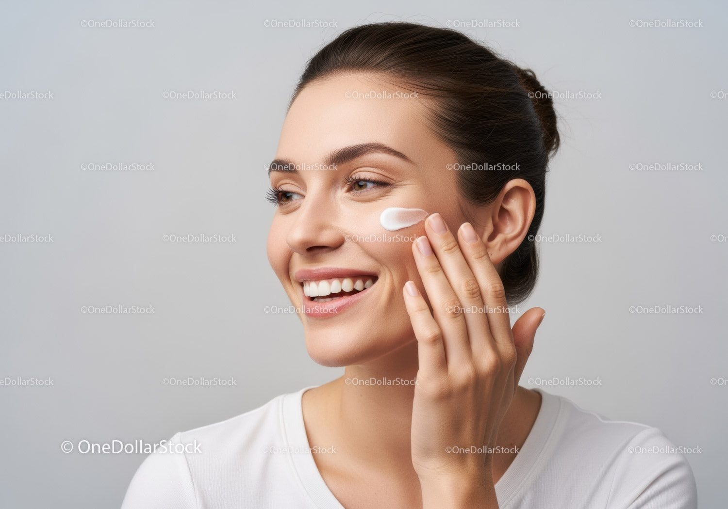 Young Woman Applying Facial Moisturizer for Healthy Skin