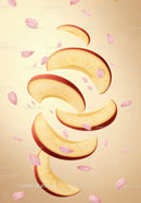 Floating apple slices with delicate pink petals