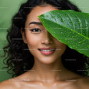 Elegant Woman with Curling Hair and Green Leaf in Natural Setting