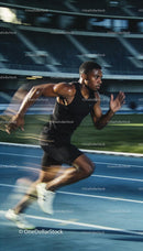 Focused Sprinter Accelerating on Outdoor Track