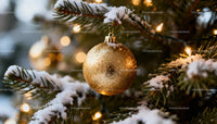 Golden Christmas Ornament on Snowy Pine Branch