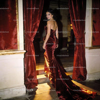 Elegant woman in deep red velvet evening gown