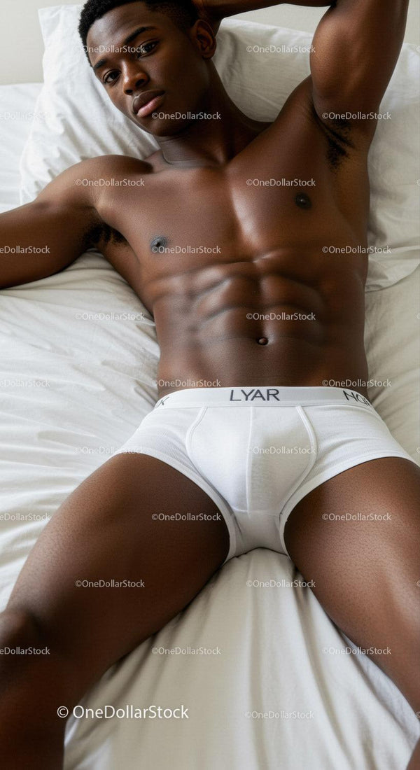 Relaxed young man lying on white bed in underwear