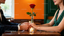 Couple Holding Hands Over Romantic Dinner Table