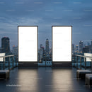 Blank illuminated billboards on rooftop with city skyline