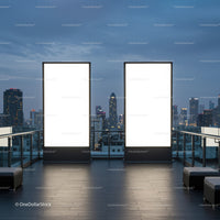 Blank illuminated billboards on rooftop with city skyline