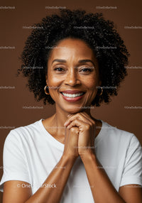 Joyful Woman with Curly Hair and Bright Smile in Studio Portrait