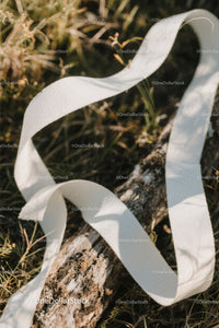 Close-up of White Plastic Ribbon Waste on Sandy Beach