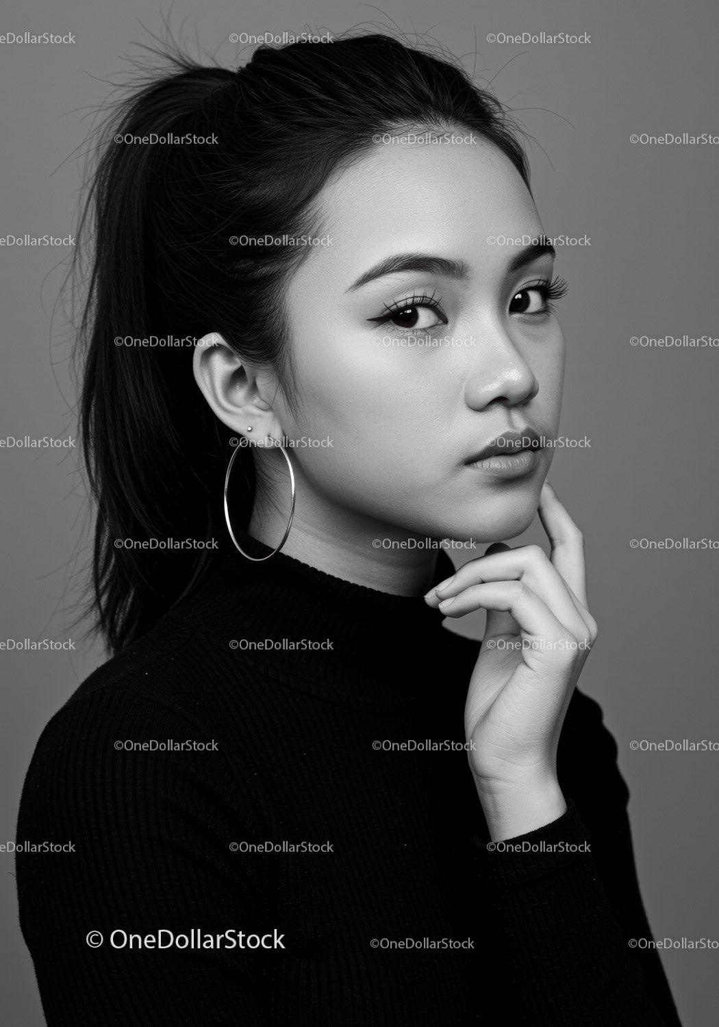 Elegant Black and White Portrait of a Young Woman with Hoop Earrings