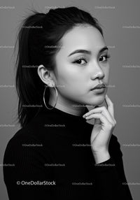 Elegant Black and White Portrait of a Young Woman with Hoop Earrings