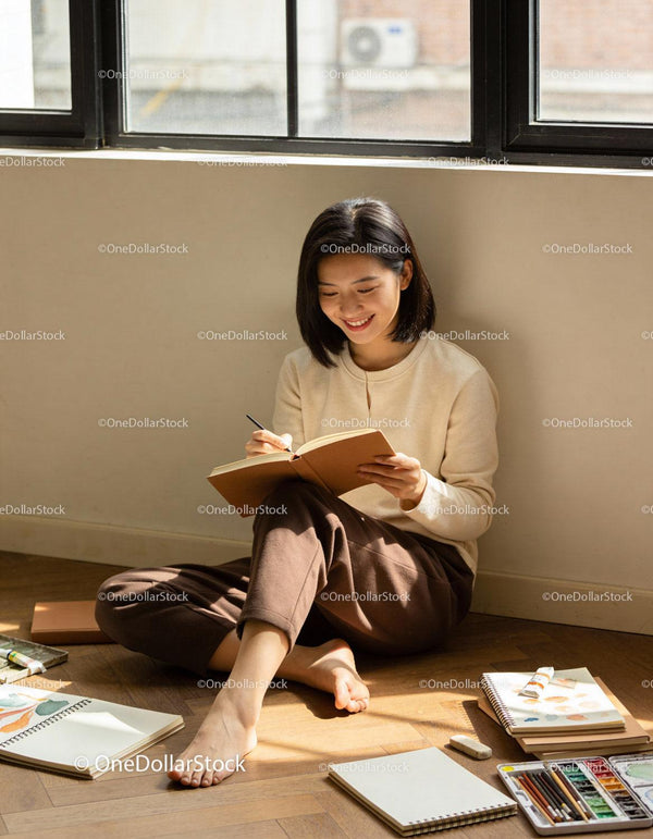 Young woman journaling in sunlit cozy corner at home