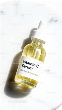 Vitamin C Serum Bottle with Dropper on Marble Surface