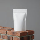 Minimalist white pouch standing on red brick surface