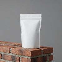 Minimalist white pouch standing on red brick surface