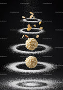 Almond covered truffles surrounded by powdered sugar rings
