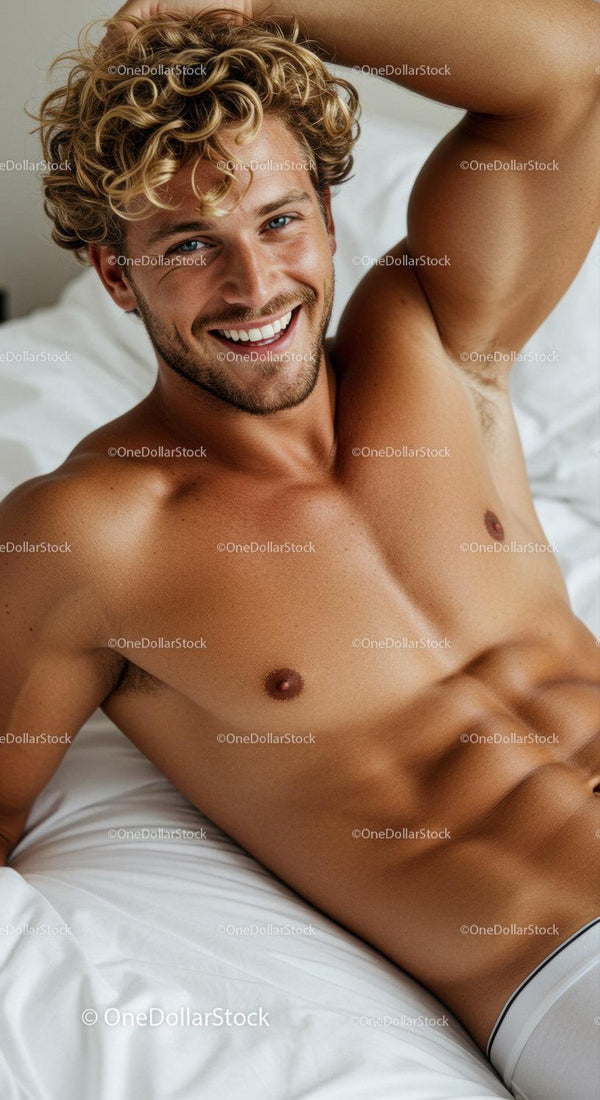 Smiling young man relaxing on white bed at home