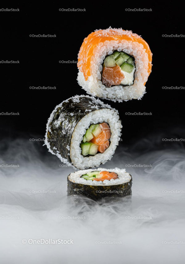 Fresh sushi rolls hovering above misty surface