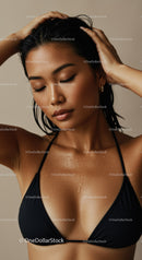 Elegant Woman with Wet Skin and Water Droplets in Black Bikini Top