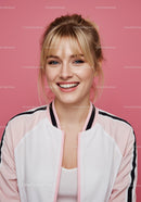 Youthful Blonde Woman Smiling in Casual Outfit on Pink Background