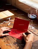 Writing a heartfelt love note by the window with wine