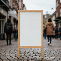 Blank wooden signboard on cobblestone street with pedestrians
