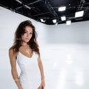 Young Woman in White Dress in Professional Studio with Bright Lighting