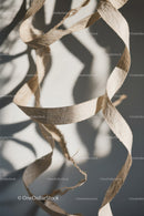 Elegant Paper Curl Art with Light Shadows and Textured Design