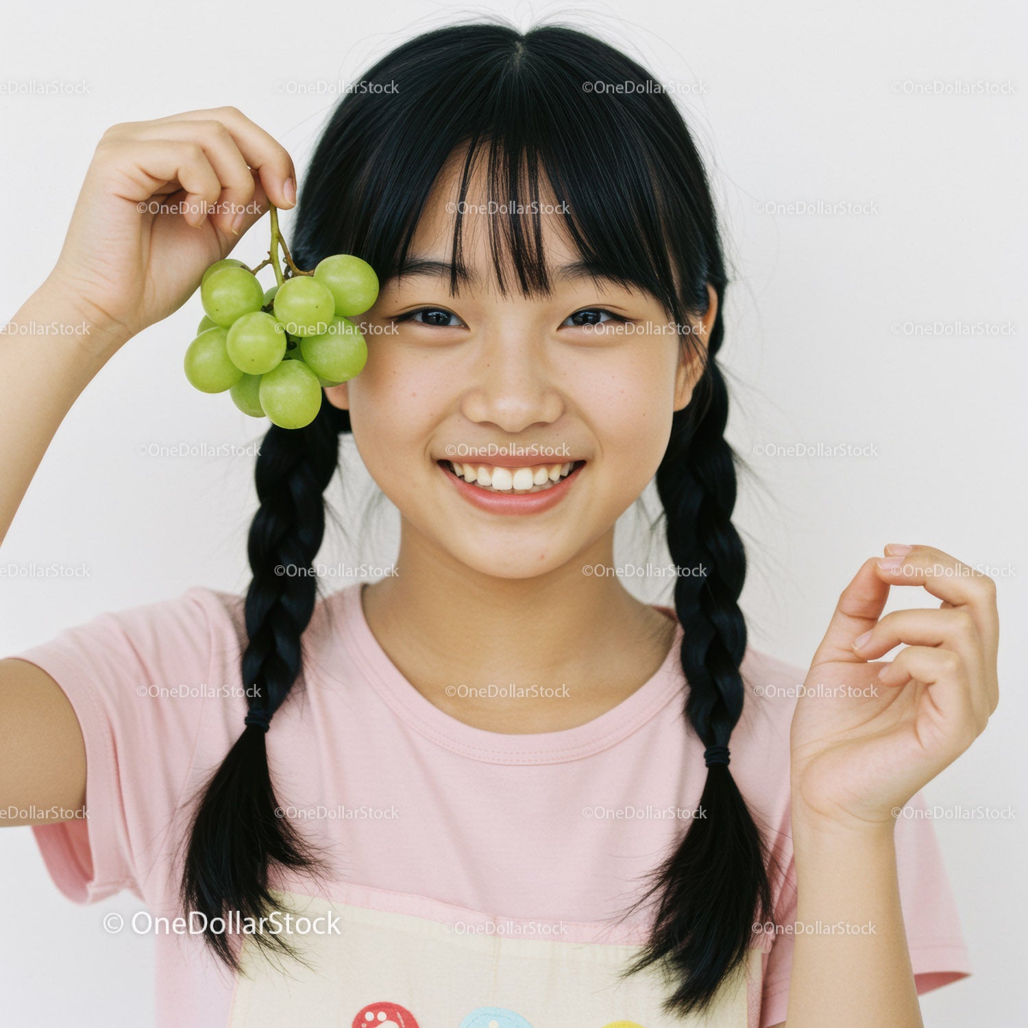 Smiling Girl Holding Green Grapes In Cheerful Indoor Portrait