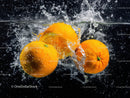 Fresh Juicy Oranges Splashing in Water with Bright Color Effect