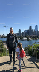 Young People Walking at City Park with Skyline View on Clear Day