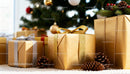 Gold wrapped Christmas gifts with pinecones under tree