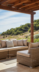Modern Outdoor Patio with Beige Wicker Sofa Overlooking Green Hills