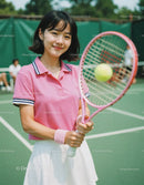 Cheerful Young Woman Playing Tennis on Outdoor Court