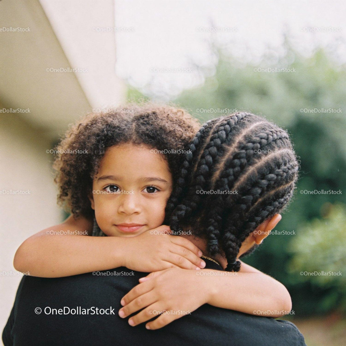 Young child embracing sibling with calm expression