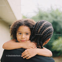 Young child embracing sibling with calm expression