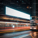 City street with glowing billboard and blurred traffic