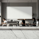 Modern cafe interior with white marble counter and baristas