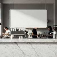 Modern cafe interior with white marble counter and baristas