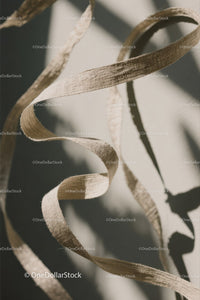 Close-up of White Plastic Ribbon Waste on Sandy Beach