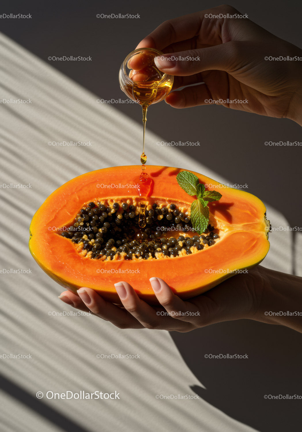 Pouring Honey Over Fresh Papaya Half with Mint